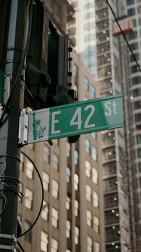 Street Sign Indicating E 42nd Street Set Against a Lively Urban Cityscape