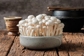 Shimeji mushrooms in a blue bowl With tea cups and Japanese bowls
