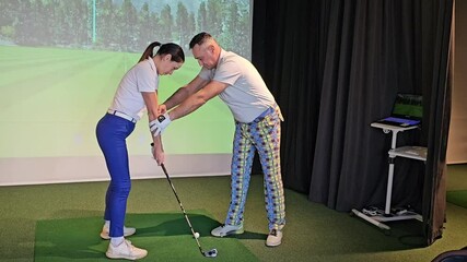 A golf instructor provides personalized guidance to a student in a high-tech indoor training facility, focusing on swing technique concept