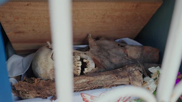 Corpse skull skeleton inside cemetery ossuary graveyard mayan traditional ethnic at Pomuch Campeche Mexico dia de los muertos day of the death