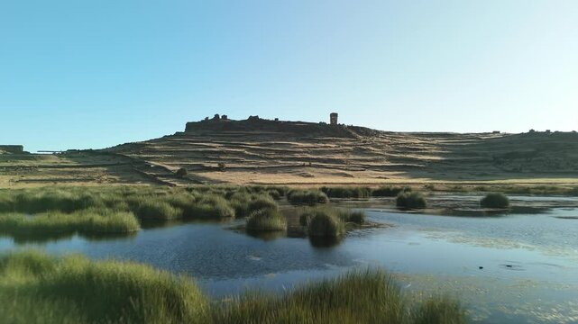 Aerial of Sillustani tomb lake complex in Puno, Flyover