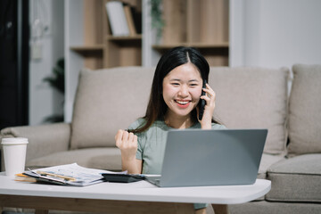 Smiling woman in headphones taking notes, motivated interested student studying online, using tablet, watching webinar training or listening to lecture, remote education concept.