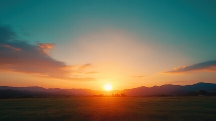 Fototapeta premium A breathtaking sunset over rolling hills, casting warm hues across the sky.