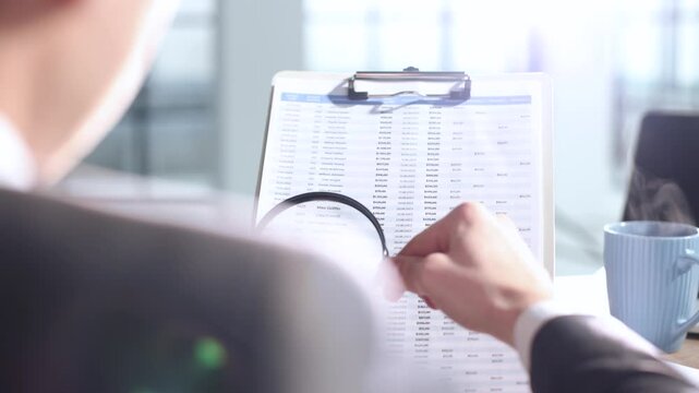 A document verification, magnifying glass, important report