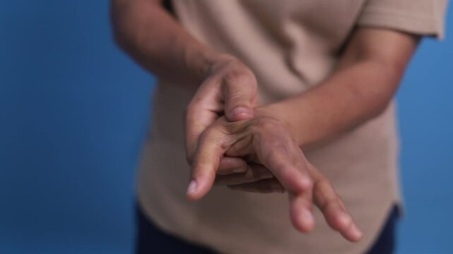 The hands of Asian elderly woman have pain to the fingers. Health and Physical Concepts