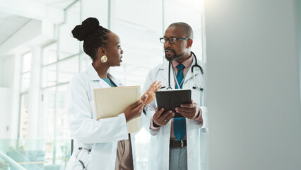 Fototapeta premium Black people, doctors and folder on discussion with tablet at clinic for telehealth, schedule and appointment. Hospital, employees and healthcare team for patient data, results and report on meeting