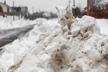 A pile of snow on the side of a road