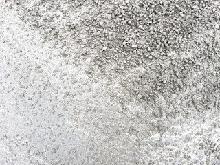 A grey and white background with a lot of small rocks