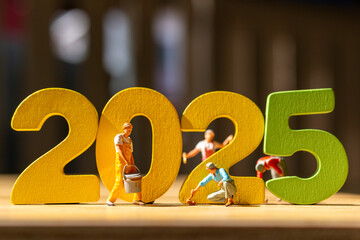 Miniature figurines painting large, colorful 2025 numbers, Perfect for New Year's promotions