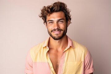 Fototapeta premium A man with a smile on his face is wearing a yellow and pink shirt