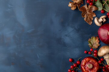 Naklejka premium Autumn-themed background with mushrooms, red onions, berries, and leaves arranged on a dark blue surface, showcasing seasonal harvest.
