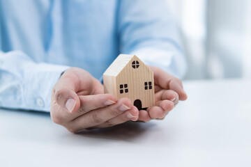 Handing over a model home real estate transaction office environment close-up perspective trust and stability concept