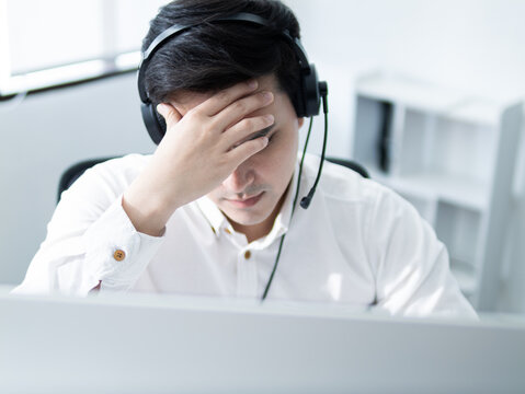 Frustrated customer service representative office environment stressful situation modern workspace close-up view work-life balance challenges