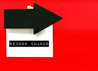 Arrow direction sign on copy space red background to SECOND CHANCE - chance to try something again...