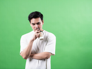 Contemplative man holding coffee studio setting portrait photography minimalist background thoughtful mood