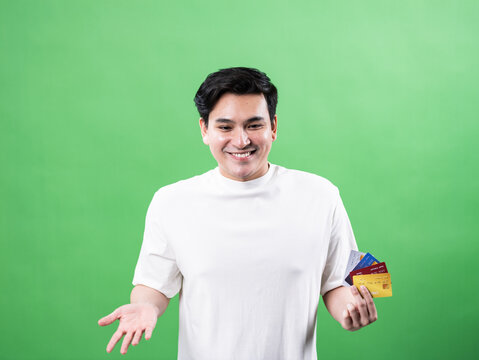 Engaging man discussing payment options green background portrait photography studio environment positive vibes for financial services