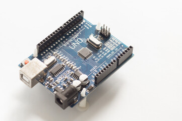 Programming board of Arduino UNO in blue colour isolated in white background