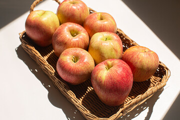 Fresh red apples in basket isolated on white background.