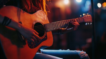 Naklejka premium A Woman Plays an Acoustic Guitar on Stage