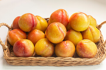 basket of fresh plums isolated on white.