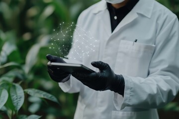 Agricultural scientist using digital tablet analyzing data in greenhouse environment