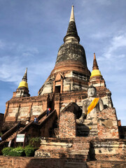 Fototapeta premium Ancient Buddhist Temple with Buddha Statue in Ayutthaya, Thailand.