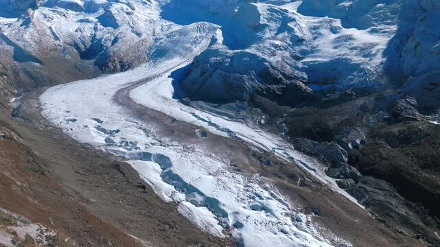Zermatt Saastal Saas Fee Swiss Alps glacial river glacier crevasse Matterhorn Valley aerial drone first snow fall autumn blue skies early morning Gornergrat railway mountain peaks forward pan up