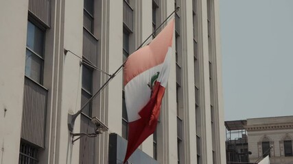 Waving National Flag Of Peru In The Facade Of A Building In Lima Province. Static Shot