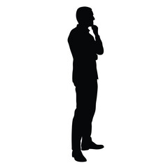 A man is standing in front of a white background. He is wearing a suit and is thinking