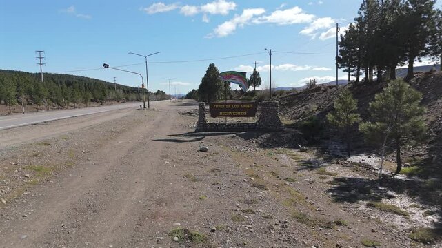 Welcome sign greeting visitors to junin de los andes, a popular fishing destination in neuquen, patagonia, argentina, featuring a large trout statue