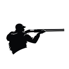 A man is holding a shotgun. He is wearing a hat. The hat is black. The jacket is black