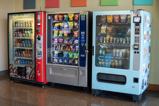 Vending machines selling snacks and drinks. Self-service machines for drinks and snacks. Cold beverage and snack vending machine in public place. Everett, WA, USA - 20 March 2024