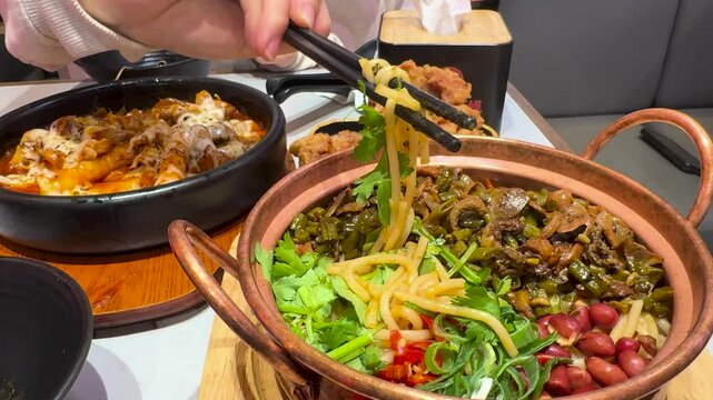 Korean cheese toppoki and Chinese oil dry noodles served with deep-fried chicken served in a restaurant in New Zealand