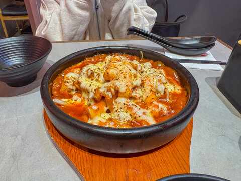 Korean cheese toppoki and Chinese oil dry noodles served with deep-fried chicken served in a restaurant in New Zealand