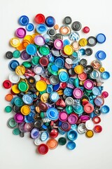 Colorful plastic bottle caps scattered on white.