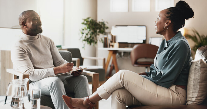 Black people, therapist or consulting with client for therapy session, discussion or counselling at office. African, man and woman with smile or help for friendly chat, emotion or therapeutic advice