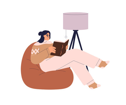 Woman reading book, relaxing on cozy bean bag chair under lamp. Reader enjoying leisure time with literature, sitting on beanbag seat at home. Flat vector illustration isolated on white background