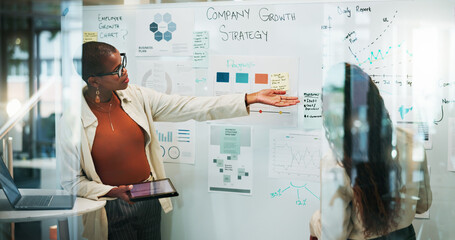 Obraz premium Business, women and meeting on whiteboard with statistics for strategy, report and planning as trend analyst. People, employees and teamwork or collaboration at office on company growth and insights