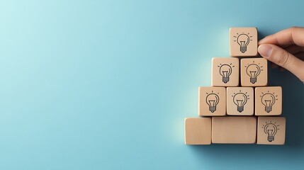 A hand is adding wooden blocks with human head idea icons