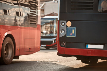 Red bus for public transportation parked on a station.