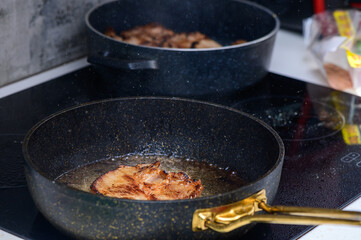 Cooking succulent pork chops in a modern kitchen with sizzling sounds filling the air