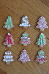 Christmas tree shaped gingerbread cookies on wooden table 