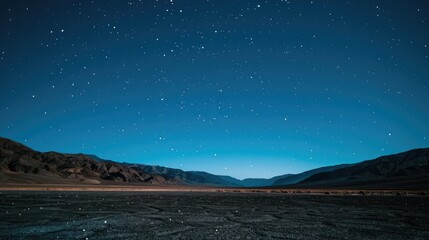 An expansive desert landscape under a starry night sky