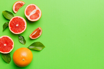 fresh Fruit grapefruit with Juicy grapefruit slices on colored background. Top view. Copy Space. creative summer concept. Half of citrus in minimal flat lay with copy space