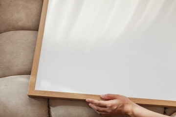 50x70 cm Frame Mockup held by a person in a modern apartment