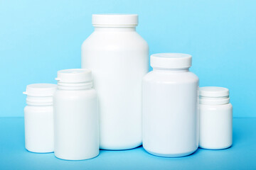 supplement pills with medicine bottle health care and medical top view. Vitamin tablets. Top view mockup bottle for pills and vitamins with green leaves, natural organic bio supplement, copy space