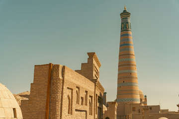 A tall building with a blue and white tower in the background