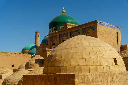 A group of domes and a building with a blue roof