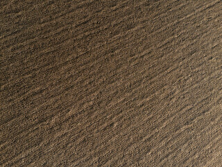 In Martani, Castell'Arquato, PC, Italy Cultivated farmland with rich brown soil ready for planting, showing lines and texture. In Martani, Castell'Arquato