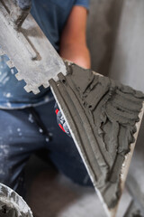 Laying porcelain tiles in the bathroom - floor tiling in a damp room - tiler workplace